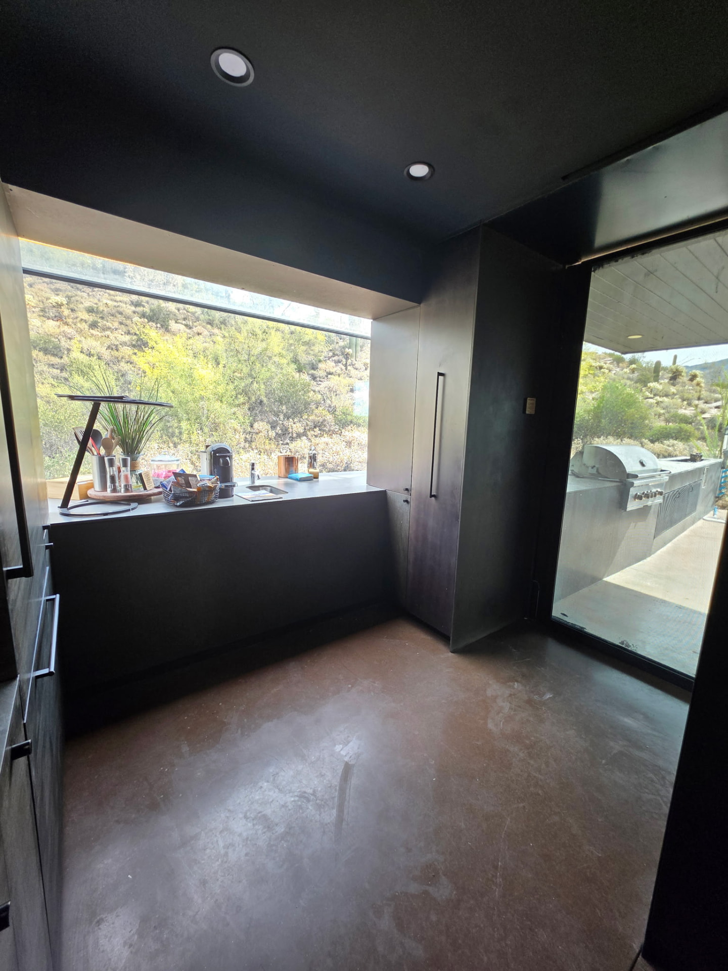 Kitchenette covered in construction dust before cleaning